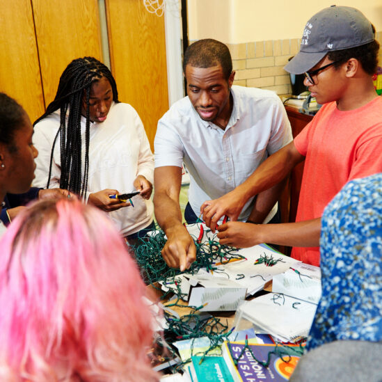 Teaching Fellow and students working on a project at Knowles Teacher Initiative